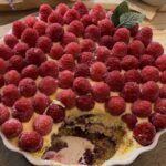Homemade raspberry tiramisu, layered with soft biscuit, mascarpone cream, raspberry jam and fresh raspberries, creating a sweet and tangy twist on the classic dessert