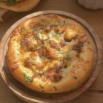 Golden-brown cheesy chicken pizza pie topped with tender chicken pieces, caramelized onions, melted cheese, and fresh herbs, served on a rustic wooden plate, perfect for pizza lovers