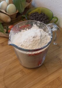 Bowl of mixed dry ingredients for Nutella muffins including flour, sugar, and baking powder.